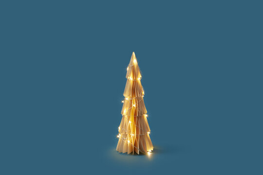 Illuminating paper Christmas tree with lights.