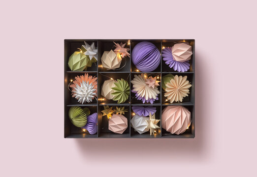 Present box with baubles and Christmas lights.