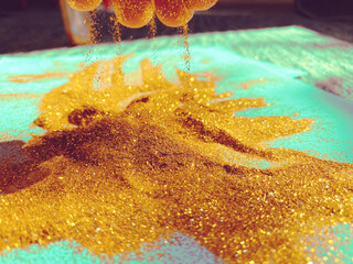 Finger play with gold glitter on New Year's Eve.
