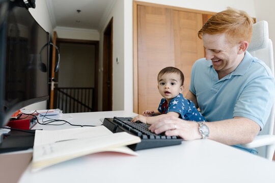 Dad working from home with a child