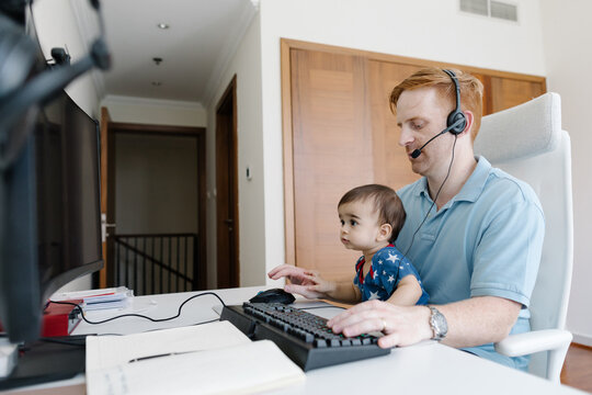 Dad working from home with a toddler