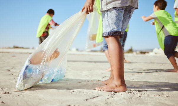 Children, legs or plastic bottles in beach clean up, climate change collection or environment sustainability recycling. Kids, diversity or students in cleaning waste management or community service