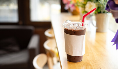 coco,iced chocolate in the cup on wooden table in coffee shop, concept food, drink and health, copy space