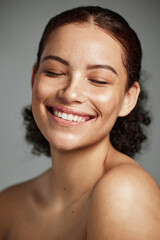 Face, beauty and skincare with a model black woman in studio on a gray background to promote...