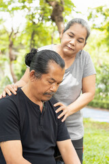 Obraz premium Old senior woman hugging, taking care of her husband suffering from Alzheimer disease