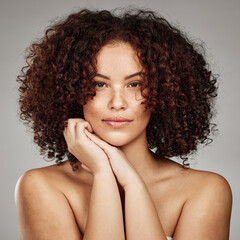 Hair care, beauty and aesthetic portrait of black woman with cosmetic afro treatment campaign. Healthy body care of hair and skincare model with natural freckles on face in gray studio.