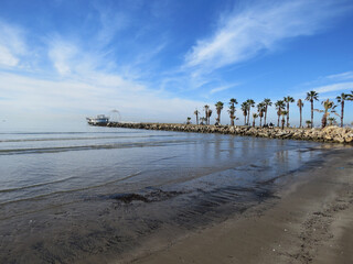 Fototapeta na wymiar Durres beach in Albania with waves and abandoned pier with palm trees