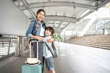 Loving Asian young mother and son hugging outdoors on a beautiful summer day. happy mother and son...