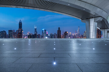 Asphalt road and bridge with city skyline at night in Shanghai, China.