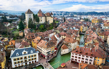 France travel and landmarks. Romantic beautiful old town of Annecy aerial drone view with medieval castle.  Haute-Savoi region