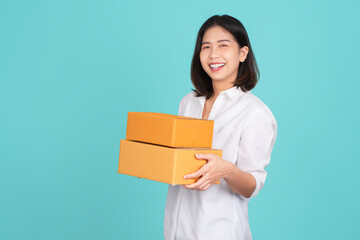 Happy Asian woman smiling wearing white shirt and holding package parcel box isolated on white background, Delivery courier and shipping service concept