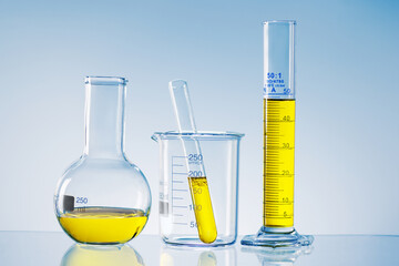 Laboratory research concept. Scientific laboratory glassware with yellow liquid.