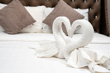 Fototapeta na wymiar Stack of clean towels on bed in bedroom. Comfortable double bed in an bedroom.