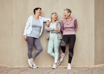 Senior women, exercise and funny with retirement, fitness and wellness, vitality and active lifestyle against wall background. Mature female friends, comedy and training, relax and sports motivation - obrazy, fototapety, plakaty