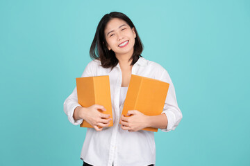 Young beautiful Asian businesswoman wearing white shirt. She is excited cardboard standing isolated on light green background, courier and courier service.