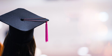 Rear view of a young Asian woman university graduate in graduation gown and cap
