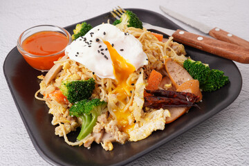 Stir-fried noodles with pork and egg, fresh vegetables, (Macro Shot)