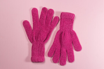 Pink gloves on a pink background. Winter accessory