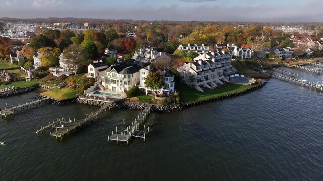 Exclusive upscale mansions on waterfront with private boat dock. Aerial view in Annapolis Maryland USA in autumn.