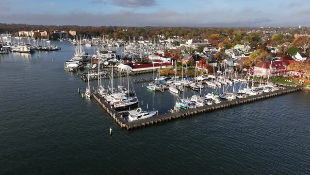 Luxury yachts in harbor at autumn golden hour. Aerial view.