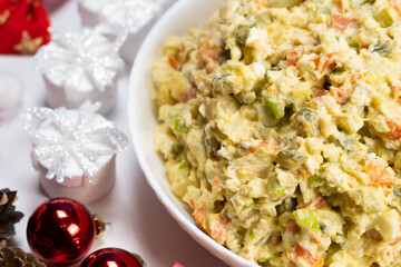 Olivier Russian salad on a Christmas and New Year background, top view. - obrazy, fototapety, plakaty