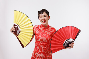 Smiling young beautiful woman holding a golden and red fan in traditional dress on isolated white background.