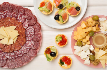 Different tasty snacks for party on wooden background, top view