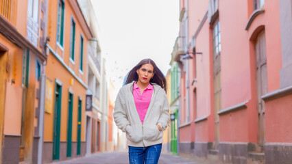 Fototapeta premium Beauty transgender woman in colorful wall looking at camera