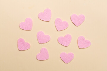 Felt hearts on color background, top view