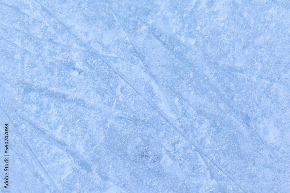 Poster empty ice rink with skate marks after the session outdoor. skating ice rink texture covered with sno