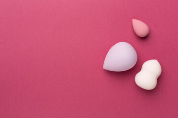 Fototapeta premium Beauty blenders on color background, top view