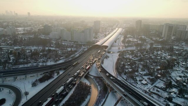Treffic in snow intersection road at sunset in the city of Warsaw in Poland at winter.