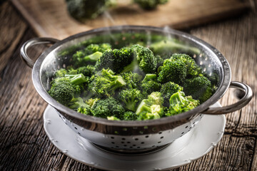 Steamed broccoli in a stainless steel steamer. Healthy vegetable concept