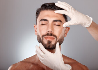 Obraz premium Plastic surgery, cosmetics and man with doctor hands in studio mockup for botox, aesthetic or facial dermatology for medical or beauty. Mesotherapy, hyaluronic acid or collagen of young model face