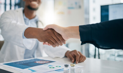 Doctor, handshake and meeting with patient, smile and greeting for vaccination education, talk or help. Black man, doctors and shaking hands with client for wellness, healthcare or medicine in clinic © Lou W/peopleimages.com