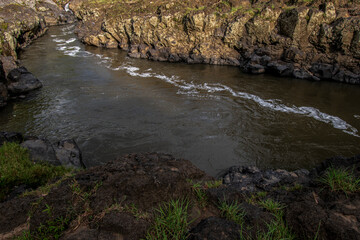 Rocky river on the right and left, swift river