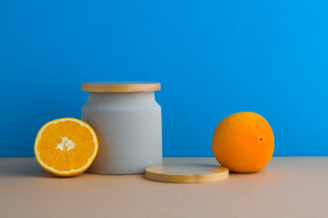 Naklejka premium A front view of citrus decorated with wooden podium in blue background