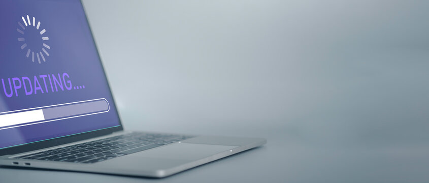 Installing software update process, operating system upgrade concept. Hand using laptop with Installing app patch or app new version updating progress bar on virtual screen.