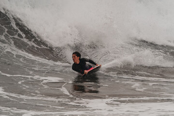 movement 2. young man surfs a wave in Telde, Gran Canaria. Canary Islands