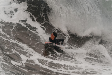 movement 3. young man surfs a wave in Telde, Gran Canaria. Canary Islands