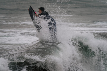 Fototapeta premium movement 4. young man surfs a wave in Telde, Gran Canaria. Canary Islands