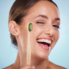 Brushing teeth, dental and woman with toothbrush, wink and beauty, oral health and fresh breath with studio background. Mouth wellness, Invisalign portrait and teeth whitening with bamboo brush.
