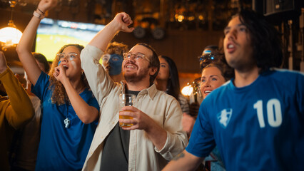 Obraz premium Soccer Club Members Cheering for Their Team, Playing in an International Cup Final. Supportive Fans Standing in a Bar, Cheering, Raising Hands and Shouting. Friends Celebrate Victory After the Goal.
