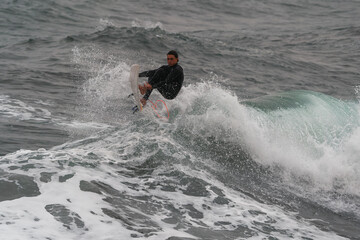 movement 2. young man surfs a wave and fails in Telde. Gran Canaria. Canary Islands