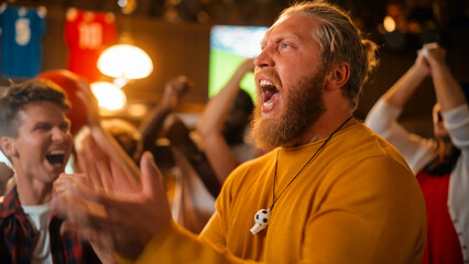 Excited Soccer Club Members Cheering for Their Team in a Pub. Supportive Fans Standing in a Bar, Cheering, Raising Hands and Shouting. Friends Celebrate Victory After the Goal.