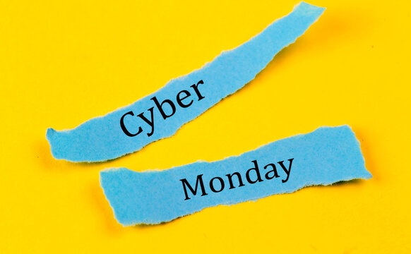 CYBER MONDAY text on a blue pieces of paper on yellow background, business concept