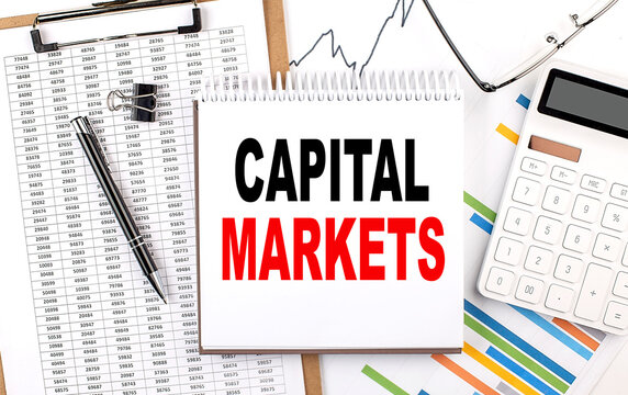 CAPITAL MARKETS text on notebook with chart, calculator and pen