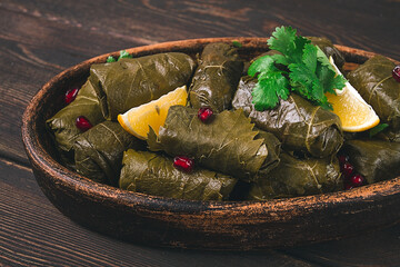 Dolma (Tolma) stuffed rolls, minced meat with rice, in grape leaves, top view, no people, close-up,