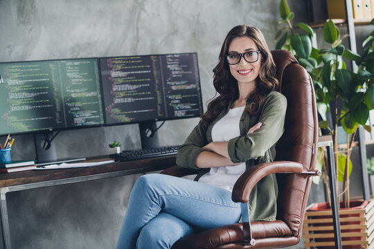 Portrait of cheerful attractive person web designer sit leather chair folded arms debugging database workstation indoors
