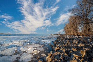 Ice drift on Dnieper river in Cherkasy city, Ukraine at sunny morning. The end of winter and the...